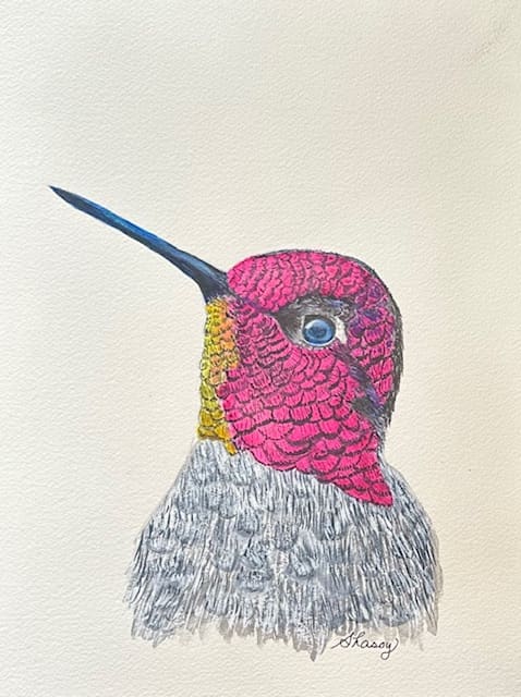 A bird with pink feathers and yellow beak.